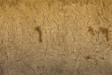 Earth house texture soil wall of traditional house made of clay and straw.