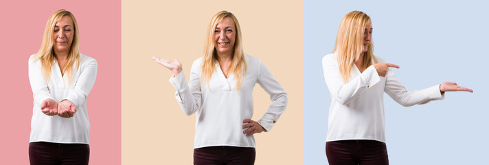 Set of Middle age blonde woman with white shirt holding copyspace imaginary on the palm to insert...