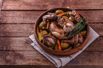 Oven baked rabbit with potato and carrots, copy space