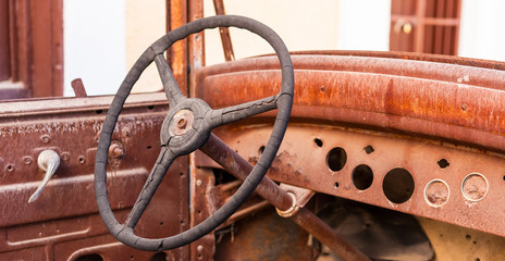Old rusty motor car steering wheel in a scrap yard © Sunshine Seeds