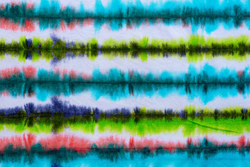 striped tie dye pattern hand dyed on cotton fabric abstract background.