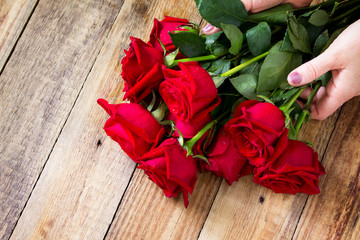 Mother day or Valentines Day, wedding card. Beautiful blooming Red roses on rustic wooden board.