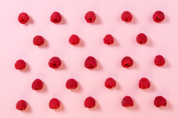 Fototapeta na wymiar Pattern of raspberry on pink background. Flat lay. Top view. Food background with summer berries. Creative minimalism