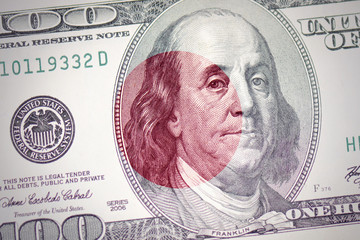Obraz na płótnie Canvas flag of japan on a american dollar money background