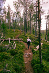 Blonde woman hiking in forest