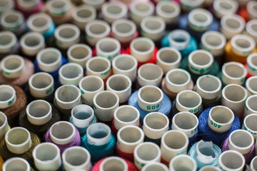 top view on closeup set of skeins of multi-colored sewing thread.Tailor industry