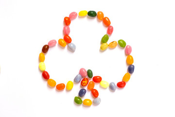 Clovers shape  made of jelly beans isolated on white