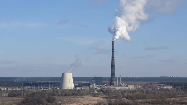 Power plant with steam and smoke raising in rge sky