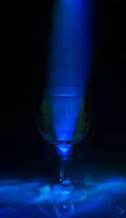 Abstract light trails and wineglass. Light Painting with Wine Glass. Wine glasses lights painting with blue and green color. 
