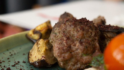 Typical Lebanese dish based on pieces of meat is roasted minced meat with a side of cooked tomatoes