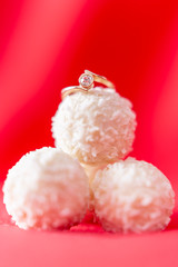 Engagement ring lying on coconut balls