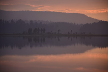 Fototapeta na wymiar See im Abendrot Bäume Spiegelung