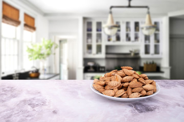 Almonds on marble table. Background is kitchen, copy space area for text