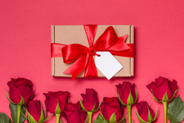 Valentines day gift ribbon bow tag, seamless red background red roses, free copy text space