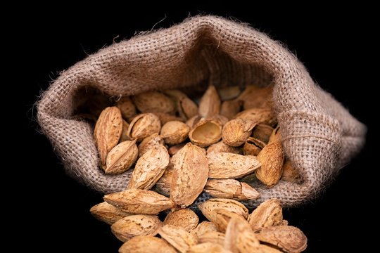 Almond nuts with shells in the jute sack bag