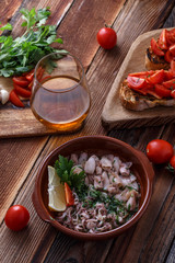 Grilled baby with garlic and lemon on wooden background