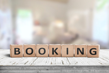 Booking sign on a wooden desk in a room