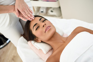 Obraz na płótnie Canvas Woman receiving head massage in spa wellness center.