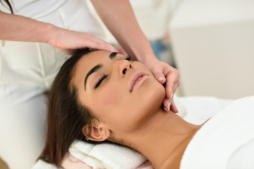 Obraz na płótnie Canvas Woman receiving head massage in spa wellness center.