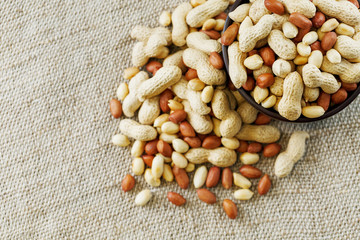 Peanuts in the shell and peeled closeup in a cup