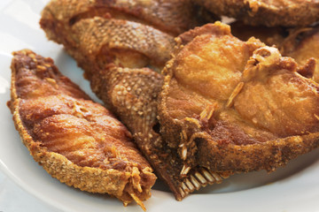 Pieces of delicious fried grouper fish on a white dish