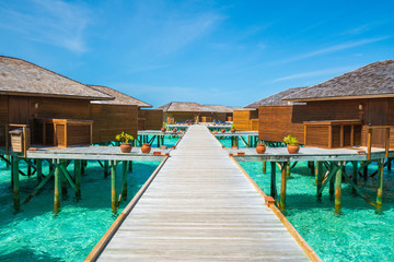 Wooden walkway to resort in Maldive.