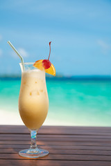 cocunut cocktail and sea background on clear sky day