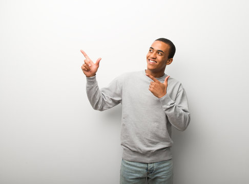 African American Man On White Wall Background Pointing With The Index Finger And Looking Up