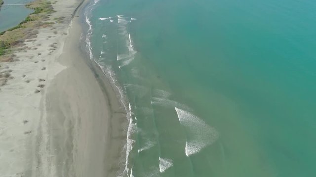Aerial view sandy beach Lingayen with azure water on island Luzon, Philippines. Seascape, ocean and beautiful beach.