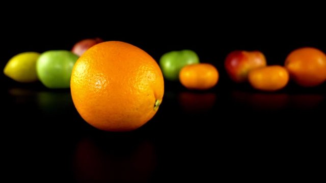The rotating orange against the background of fruit.
