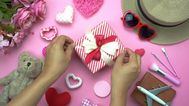 Happy valentines Day & clothing travel women background concept.During preparation & arrangement the essential  decorations for my love in festival.Gift box & heart with rose flower on pink paper