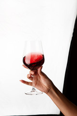 hand holding a glass of red wine