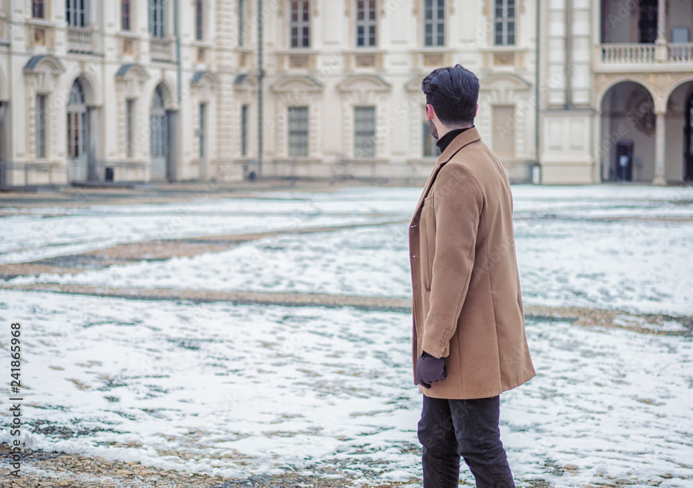 Wall mural handsome trendy man wearing elagant jacket, outdoor in city setting in winter day shot