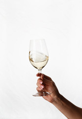 hand holding a glass of white wine