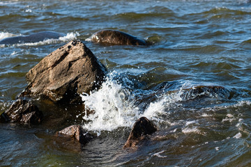 waves on the rocks and stones in the sea