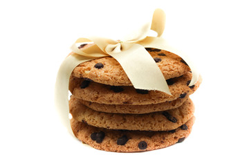 Oatmeal cookies with chocolate drops, tied with a golden ribbon, isolated on white background