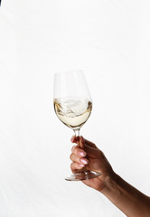 hand holding a glass of white wine