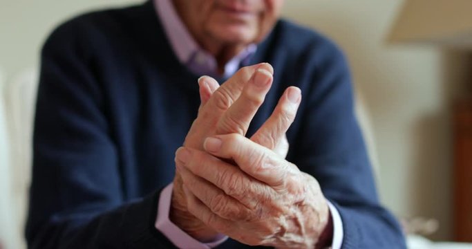 Senior Man At Home Suffering Pain With Arthritis In Hand