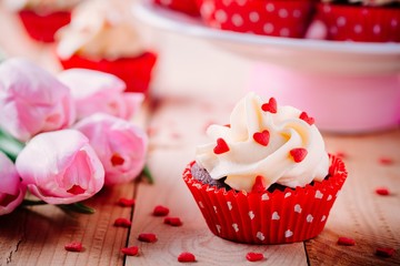 Chocolate cupcakes with vanilla cream and red sugar hearts for Valentine's Day