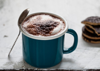 cup of coffee with cream on wooden background
