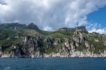 Obraz premium rocky island in the sea, mountain and clouds