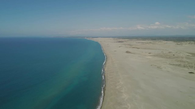 Aerial view lonely beach and Paoay sand dune. Philippines, Luzon. Sand dunes near to the sea with sky. Ilocos Norte.