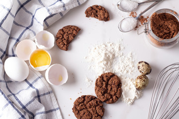 Fototapeta na wymiar chocolate cookies and baking ingredients on white background.