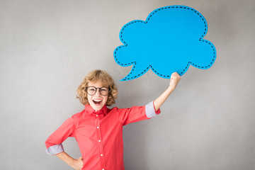 Happy child holding paper speech bubble