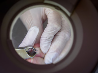 Female chiropodist working on a senior clients feet.