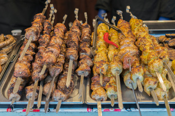Meat on the skewer. Fried meat on a tray close up