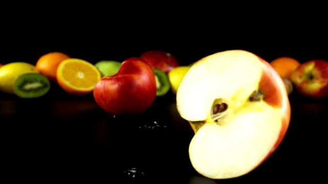 Falling of apple against the background of fruit. Slow motion.

