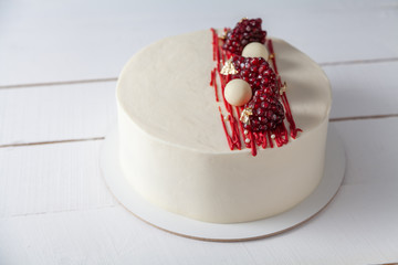 White cake on a white plate. Sweetness from the pastry chef in the style of minimalism.