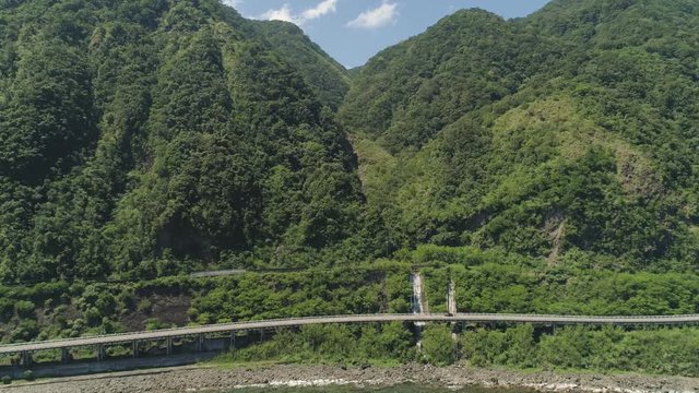 Aerial view Patapat viaduct in coast Pagudpud, Ilocos Norte. Highway with bridge by coast sea near the mountains. Philippines, Luzon. Highway along the coast.