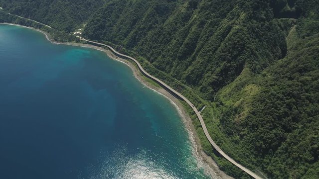 Aerial view Patapat viaduct in coast Pagudpud, Ilocos Norte. Highway with bridge by coast sea near the mountains. Philippines, Luzon. Highway along the coast.